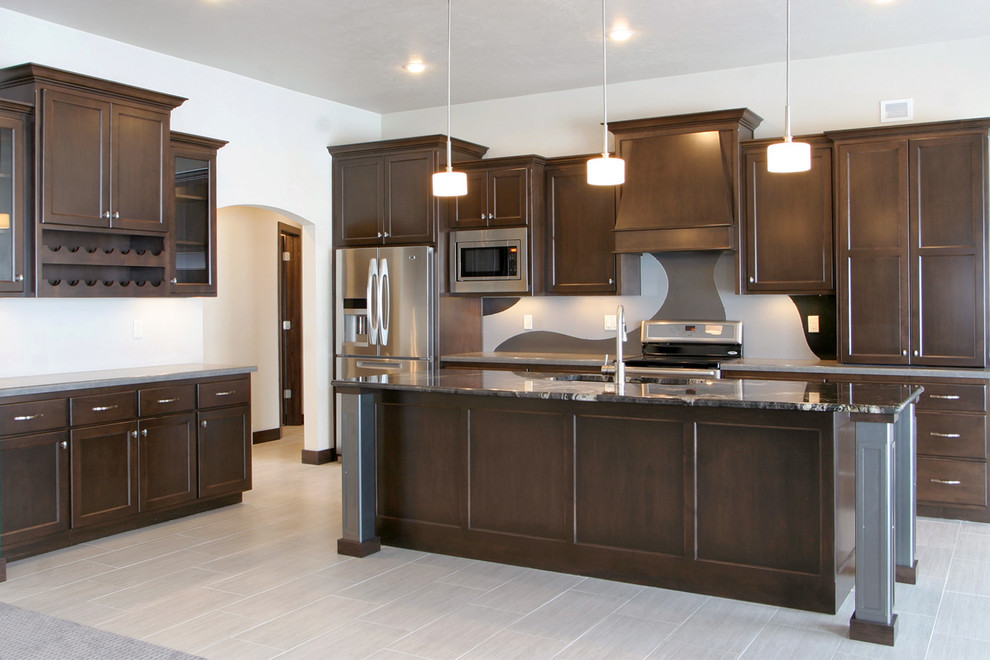 Inspiration for a large transitional l-shaped porcelain tile and gray floor open concept kitchen remodel with an undermount sink, shaker cabinets, dark wood cabinets, granite countertops, multicolored backsplash, glass sheet backsplash, stainless steel appliances and an island
