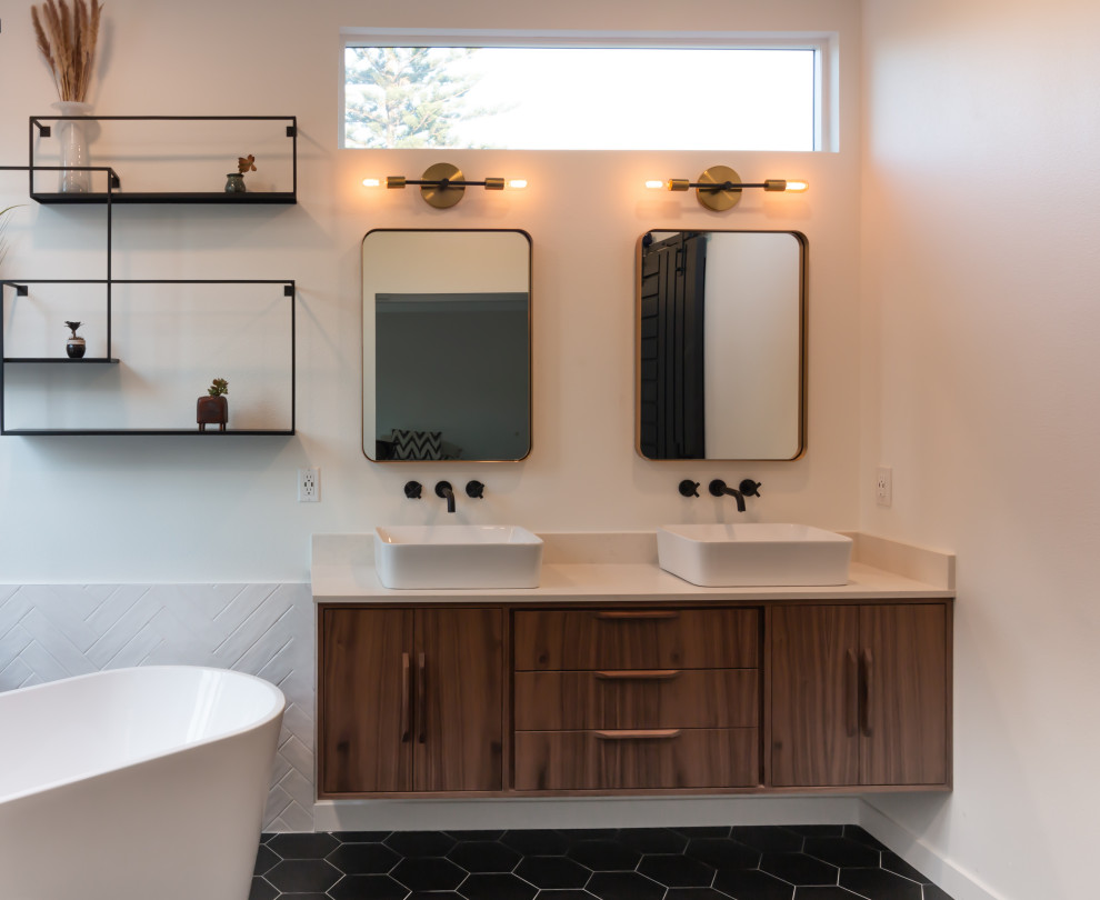 Midcentury bathroom in Orange County with flat-panel cabinets, brown cabinets, a freestanding tub, a corner shower, black and white tile, porcelain tile, white walls, porcelain floors, a vessel sink, engineered quartz benchtops, black floor, a hinged shower door, white benchtops, a shower seat, a double vanity and a floating vanity.
