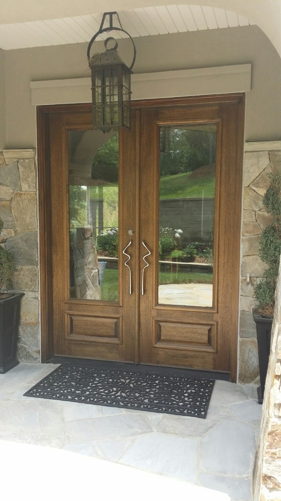 Inspiration for a traditional front door in Charlotte with a double front door and a medium wood front door.