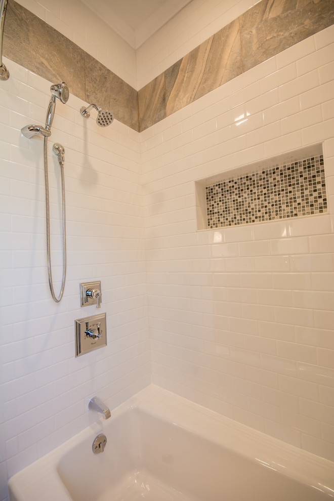 This is an example of a large traditional kids bathroom in Providence with furniture-like cabinets, distressed cabinets, marble benchtops, gray tile, porcelain tile, an alcove tub, a shower/bathtub combo, a two-piece toilet, a trough sink, beige walls and porcelain floors.