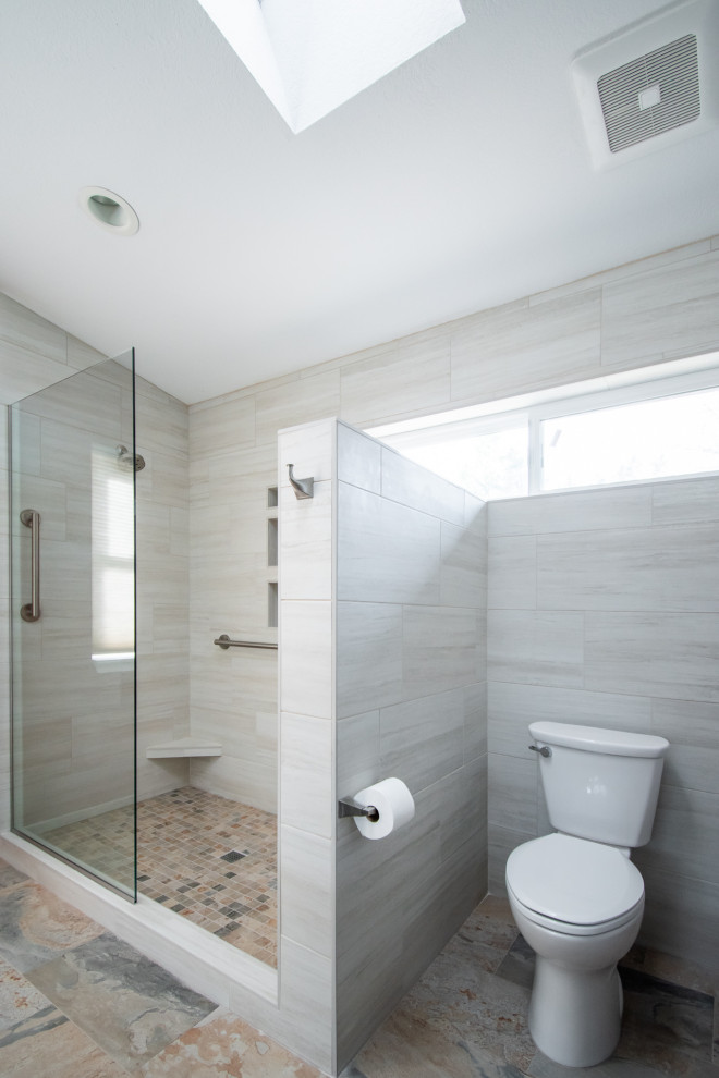 Inspiration for an expansive transitional master bathroom in Portland with shaker cabinets, blue cabinets, a corner shower, a two-piece toilet, beige tile, ceramic tile, red walls, porcelain floors, an undermount sink, engineered quartz benchtops, beige floor, an open shower, grey benchtops, a niche, a double vanity and a built-in vanity.