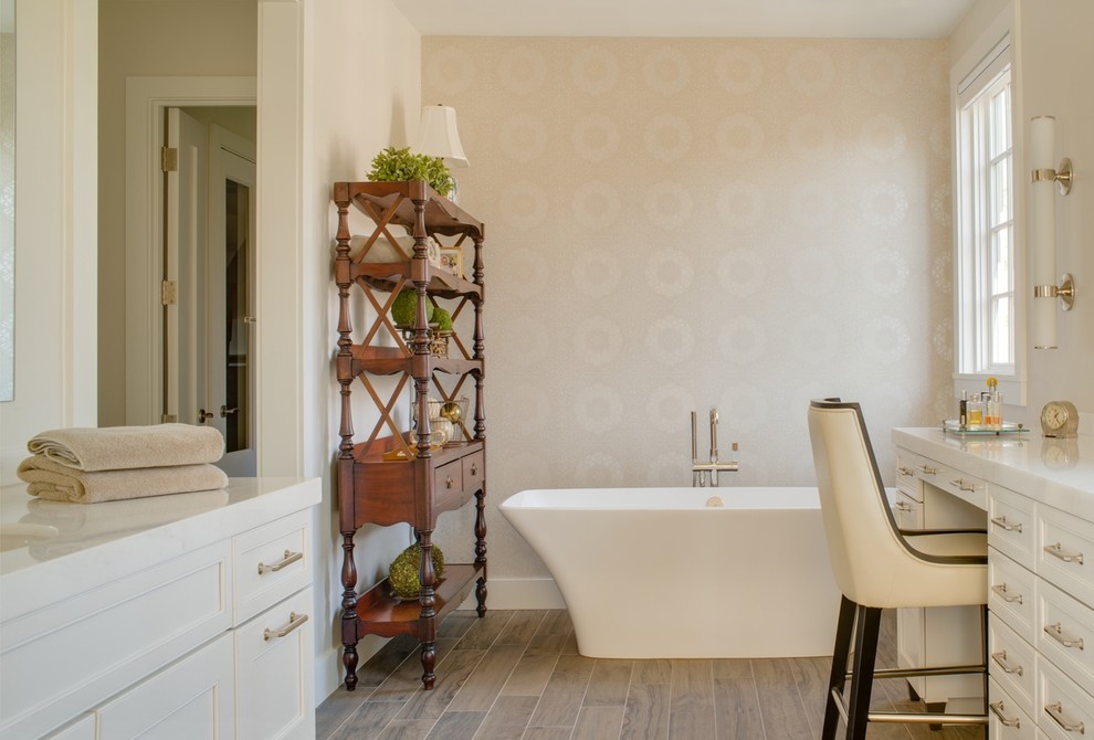 Freestanding bathtub - large transitional master brown tile and porcelain tile porcelain tile freestanding bathtub idea in DC Metro with an undermount sink, recessed-panel cabinets, white cabinets, marble countertops and beige walls