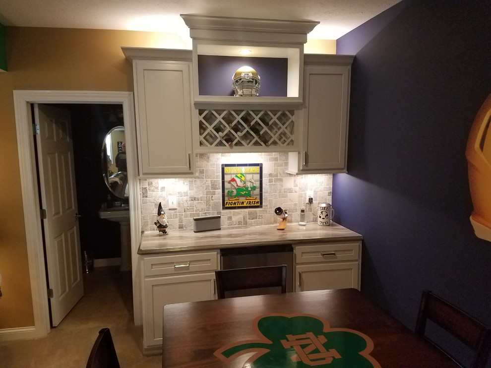 Basement - mid-sized transitional underground carpeted and beige floor basement idea with multicolored walls and no fireplace