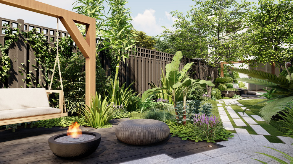 Ispirazione per un giardino tropicale esposto a mezz'ombra di medie dimensioni e dietro casa in estate con un ingresso o sentiero, pedane e recinzione in legno