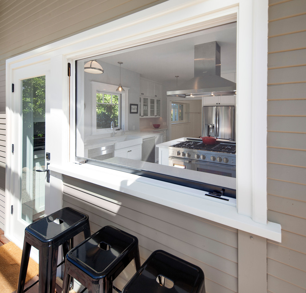 Large transitional u-shaped porcelain tile and gray floor enclosed kitchen photo with a farmhouse sink, shaker cabinets, white cabinets, quartz countertops, multicolored backsplash, ceramic backsplash, stainless steel appliances, a peninsula and white countertops