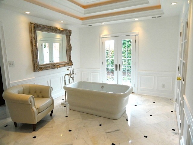 Inspiration for a mid-sized contemporary master bathroom in Louisville with a freestanding tub, white walls and porcelain floors.