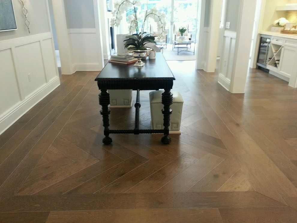 Foyer - mid-sized transitional medium tone wood floor and brown floor foyer idea in Orlando with gray walls