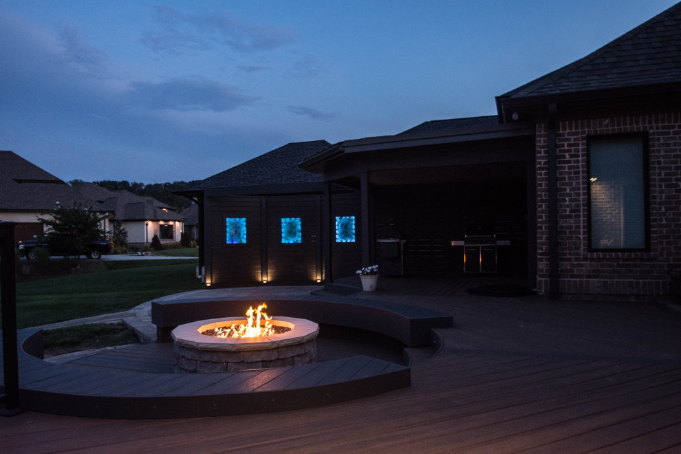 Large transitional backyard deck photo with a fire pit and no cover