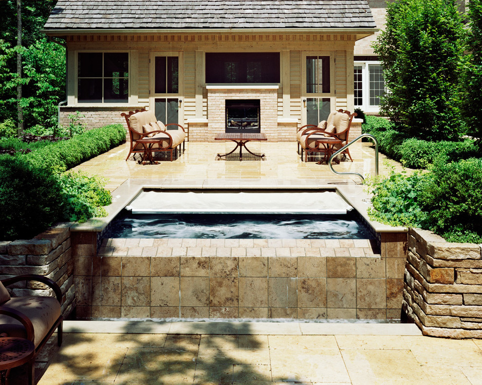 This is an example of a small traditional backyard rectangular pool in Chicago with a hot tub.