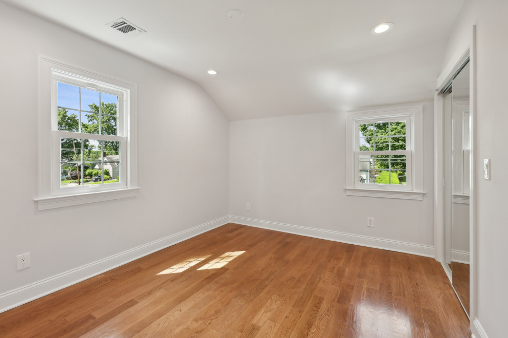 Bedroom with Sloped Ceiling and Mirrored Closet
