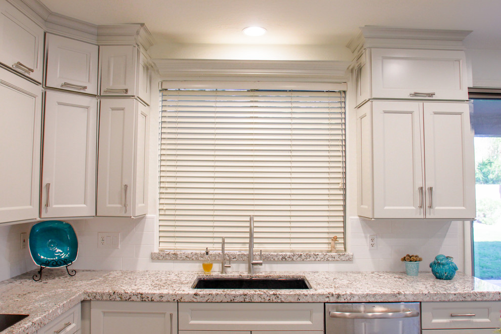 Mid-sized transitional u-shaped porcelain tile and gray floor eat-in kitchen photo in Phoenix with a double-bowl sink, shaker cabinets, gray cabinets, granite countertops, white backsplash, subway tile backsplash, stainless steel appliances, an island and white countertops