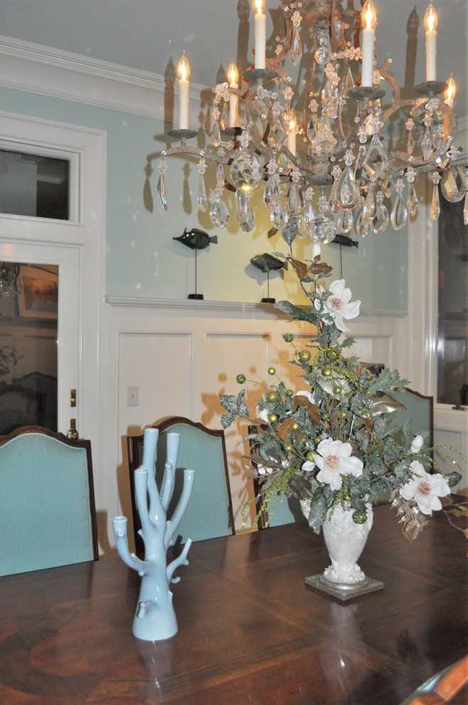 This is an example of a mid-sized beach style separate dining room in Wilmington with blue walls, dark hardwood floors, no fireplace and brown floor.