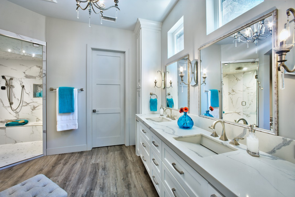 Inspiration for a mid-sized transitional master white tile and porcelain tile vinyl floor, brown floor and double-sink bathroom remodel in Sacramento with shaker cabinets, white cabinets, a two-piece toilet, gray walls, an integrated sink, quartz countertops, a hinged shower door, white countertops and a built-in vanity