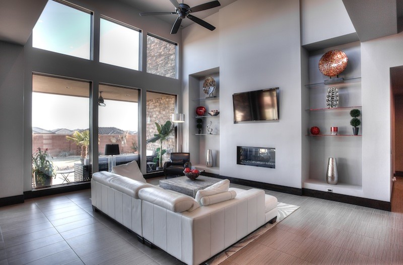Mid-sized contemporary family room in Salt Lake City with grey walls, porcelain floors, a ribbon fireplace, a wall-mounted tv and grey floor.