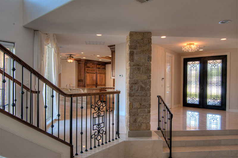 Example of a large transitional marble floor foyer design in Dallas with white walls and a black front door