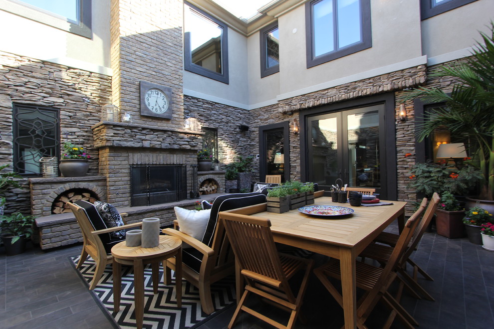 Inspiration for a traditional courtyard patio in San Diego with a fire feature.