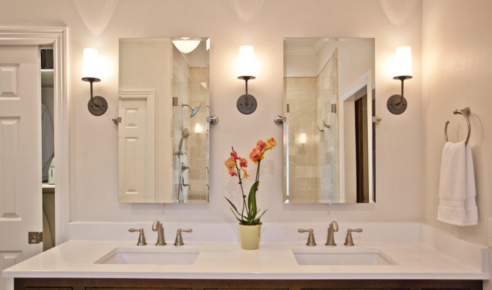 Large transitional master ceramic tile and beige floor alcove shower photo with recessed-panel cabinets, brown cabinets, a one-piece toilet, white walls, an undermount sink, quartzite countertops and a hinged shower door