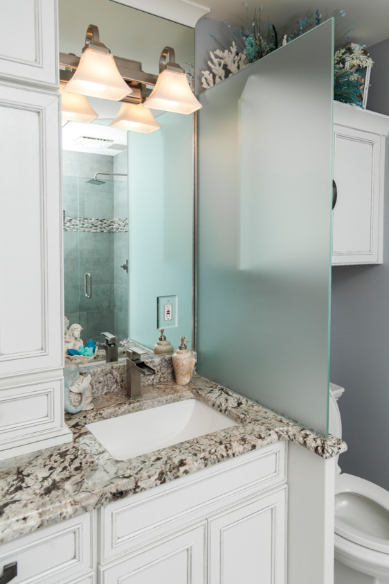 Drop-in bathtub - small coastal master porcelain tile and gray floor drop-in bathtub idea in Atlanta with recessed-panel cabinets, blue walls, an undermount sink and granite countertops