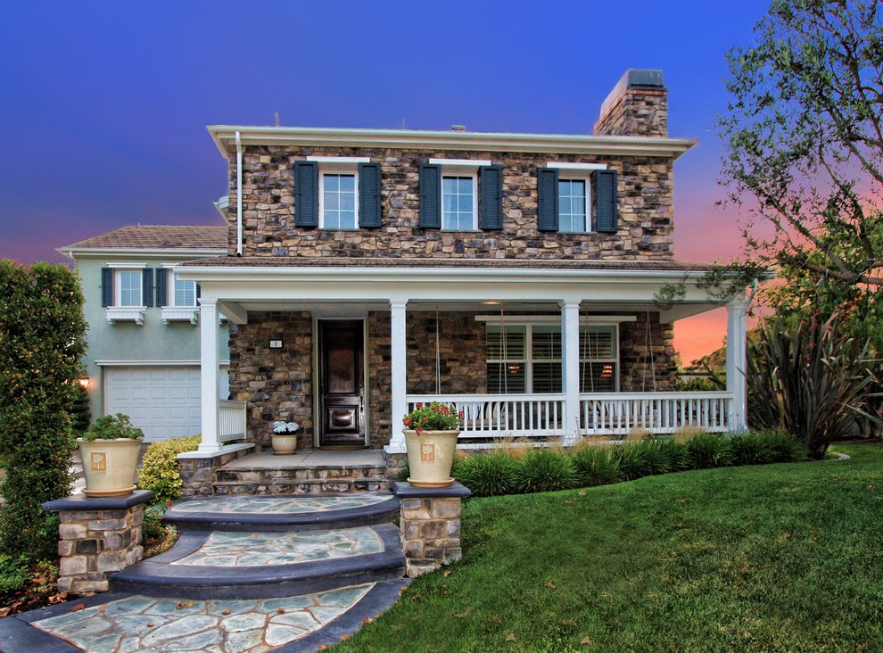 Photo of a traditional exterior in Orange County with stone veneer.