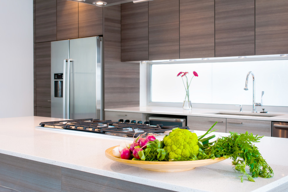 Photo of a contemporary single-wall eat-in kitchen in Houston with flat-panel cabinets, grey cabinets, quartz benchtops, yellow splashback, glass sheet splashback and stainless steel appliances.