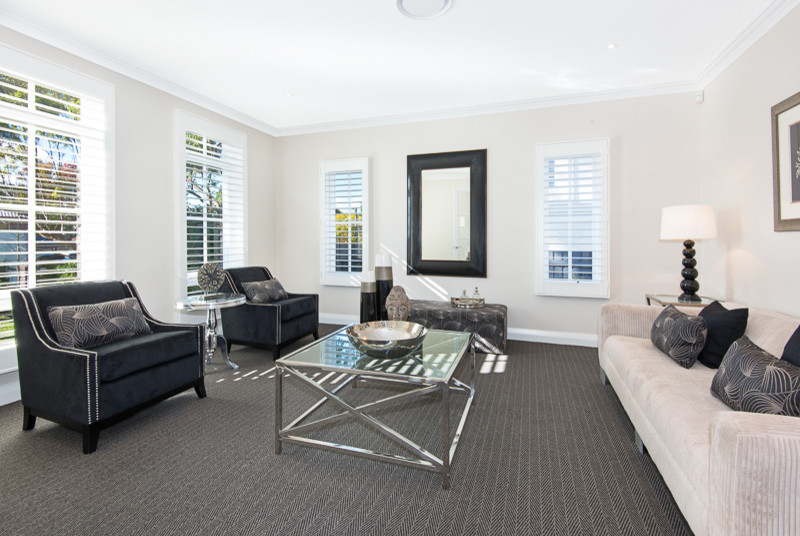 Inspiration for a large contemporary formal enclosed living room in Sydney with beige walls and carpet.