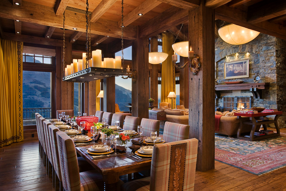 This is an example of a country dining room in Other with dark hardwood floors.