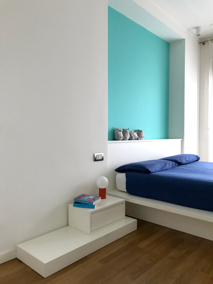Design ideas for a mid-sized contemporary master bedroom in Milan with multi-coloured walls and light hardwood floors.