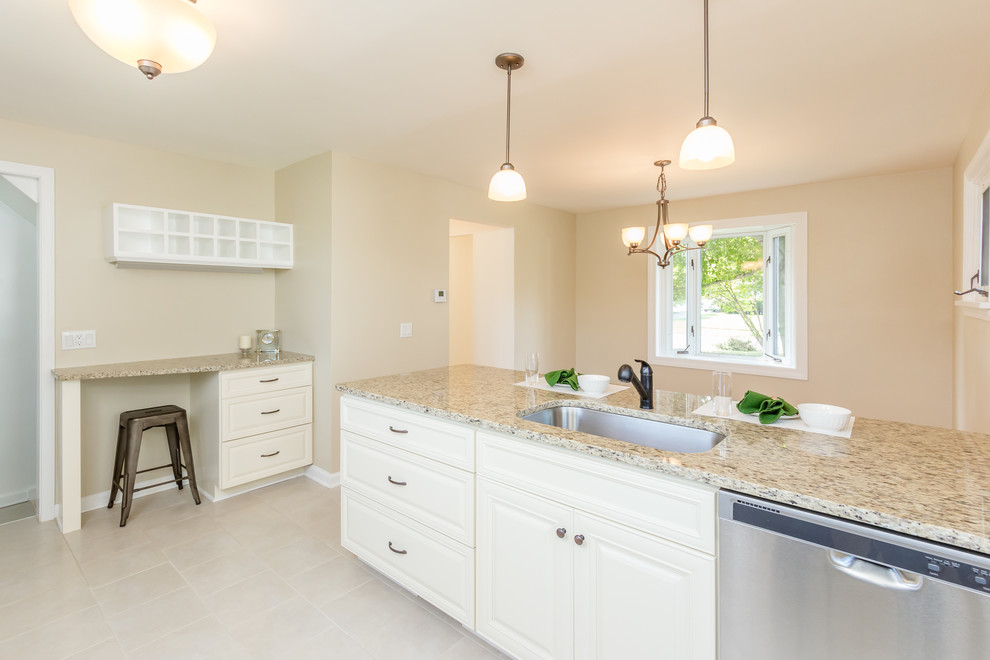 Mid-sized u-shaped eat-in kitchen in New York with an undermount sink, raised-panel cabinets, light wood cabinets, granite benchtops, beige splashback, ceramic splashback, stainless steel appliances, porcelain floors, with island and white floor.