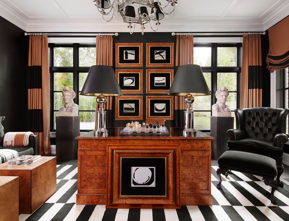 Traditional study room in New York with black walls and a freestanding desk.