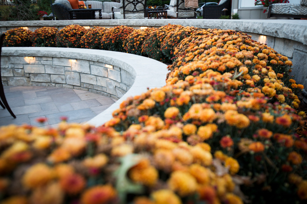 Design ideas for a transitional backyard stone water fountain landscape in Omaha.