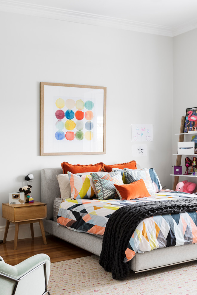 This is an example of a contemporary kids' room in Melbourne with white walls, medium hardwood floors and brown floor.