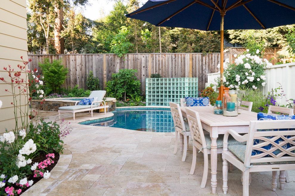 Photo of a mid-sized traditional backyard patio in San Francisco with natural stone pavers.