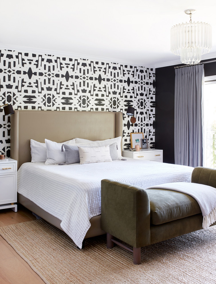 Large contemporary master bedroom in Los Angeles with black walls, medium hardwood floors, beige floor and wallpaper.