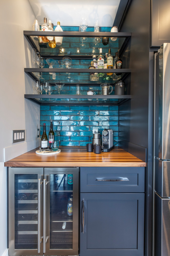 Photo of a large midcentury home bar in Cleveland with shaker cabinets, wood benchtops, blue splashback and ceramic splashback.