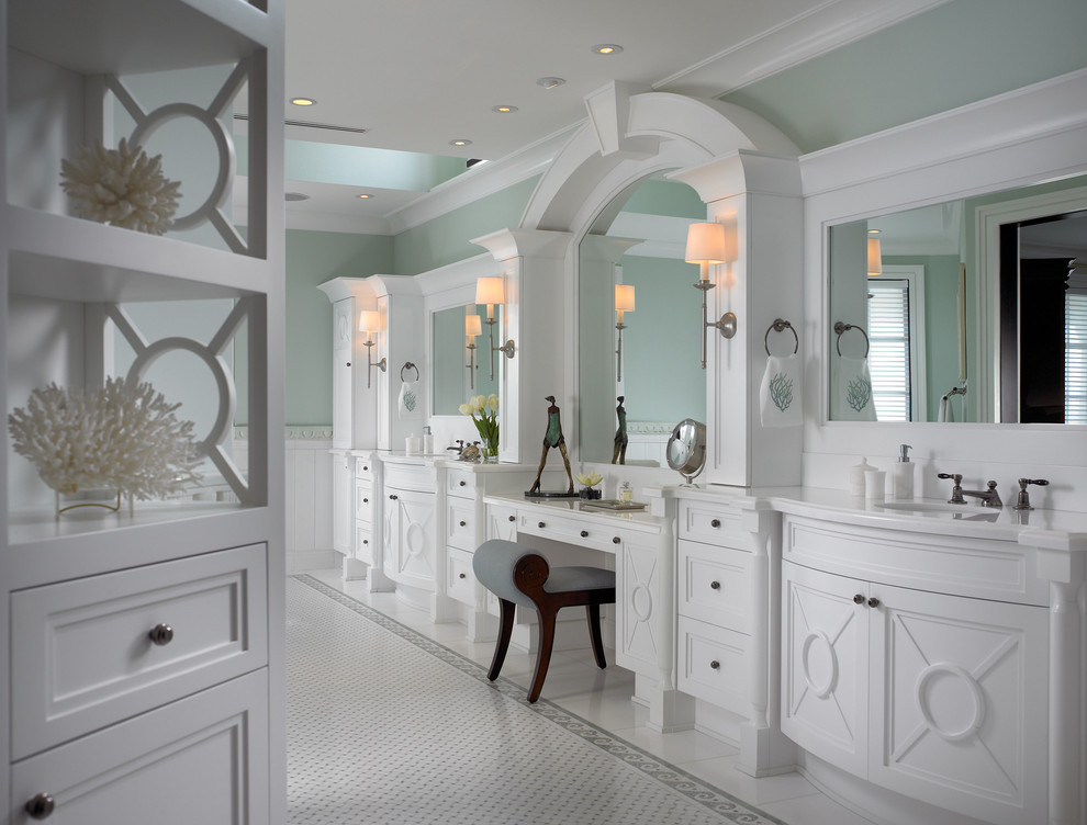 This is an example of a beach style bathroom in Miami with white cabinets, marble benchtops, mosaic tile and marble floors.