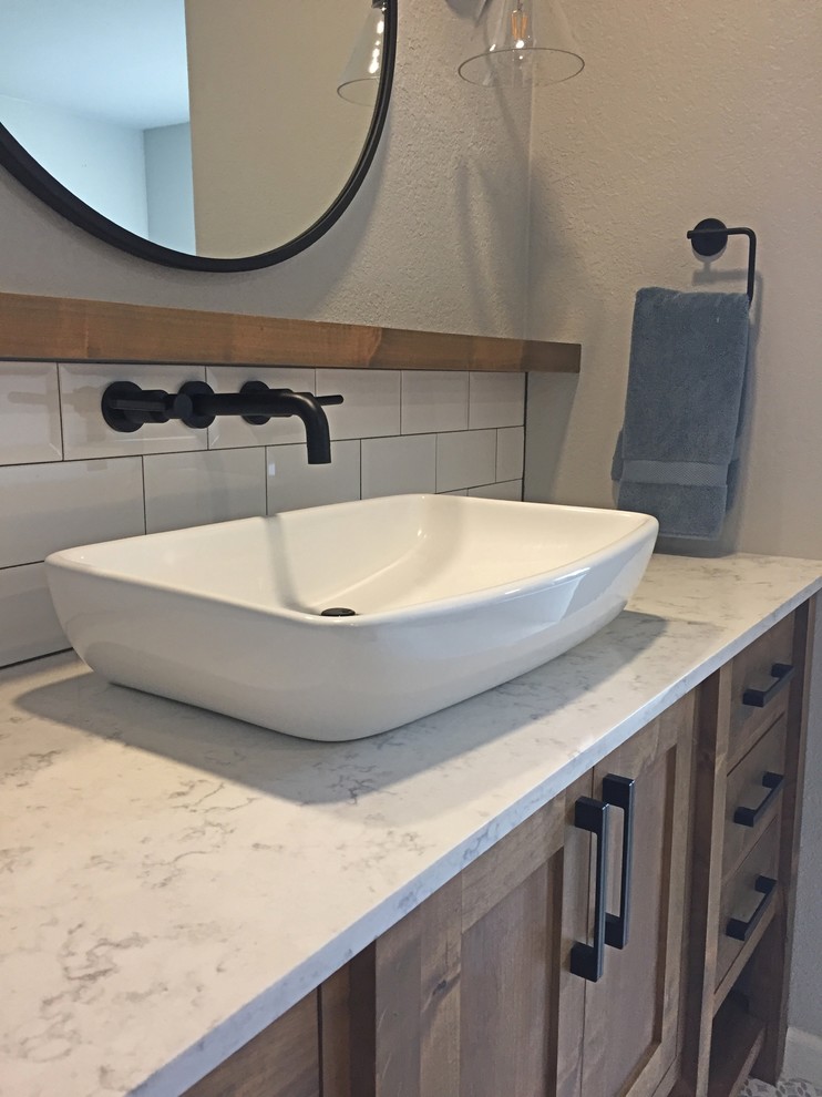 Mid-sized country master bathroom in Oklahoma City with shaker cabinets, medium wood cabinets, a freestanding tub, porcelain floors, a vessel sink, engineered quartz benchtops and white floor.