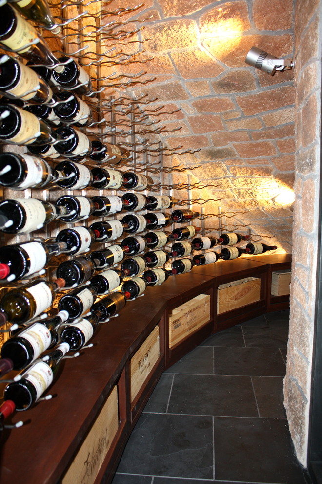 Small contemporary wine cellar in Dallas with porcelain floors and storage racks.