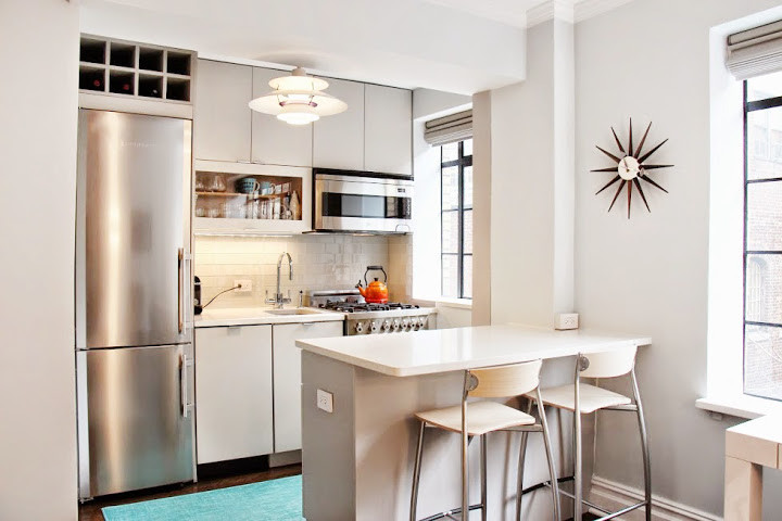Small minimalist galley dark wood floor and brown floor open concept kitchen photo in New York with an undermount sink, gray cabinets, quartz countertops, white backsplash, glass tile backsplash, stainless steel appliances, a peninsula and flat-panel cabinets