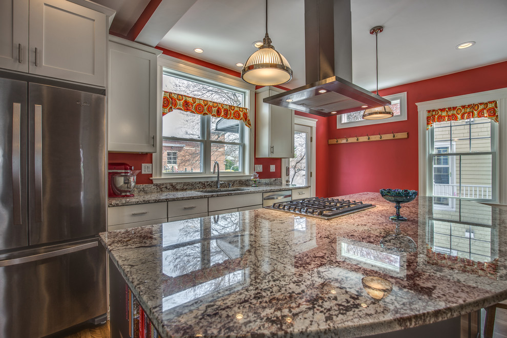 Example of a mid-sized transitional galley light wood floor and beige floor eat-in kitchen design in Boston with an undermount sink, shaker cabinets, white cabinets, granite countertops, red backsplash, stainless steel appliances and an island