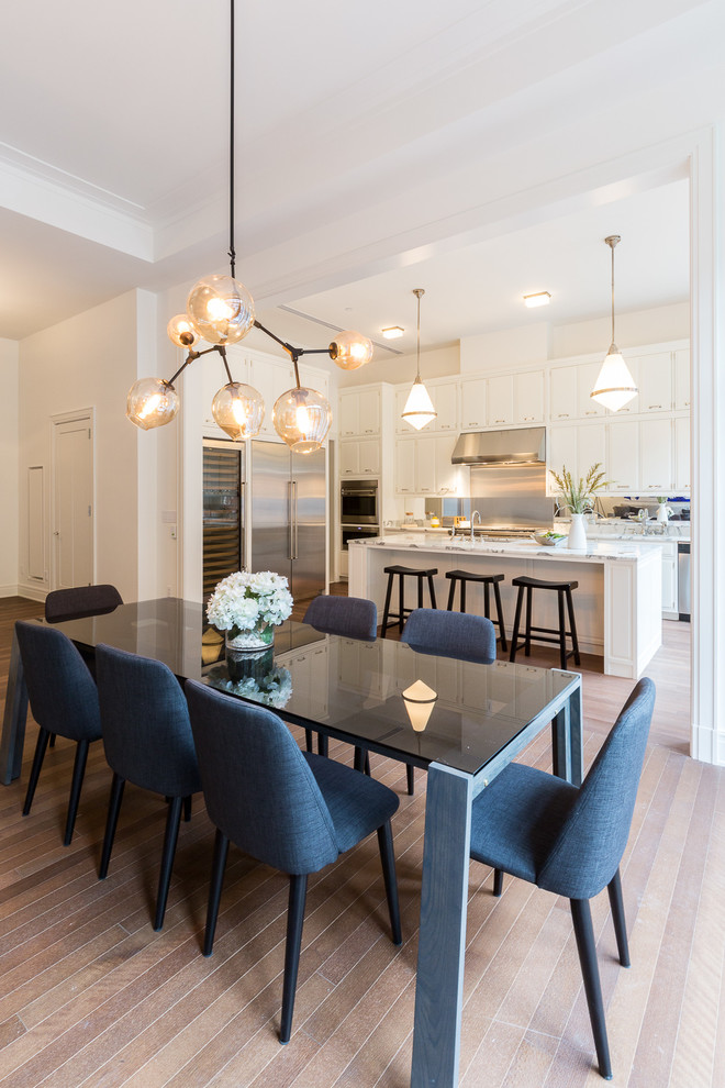 Design ideas for a contemporary open plan dining in New York with white walls and medium hardwood floors.