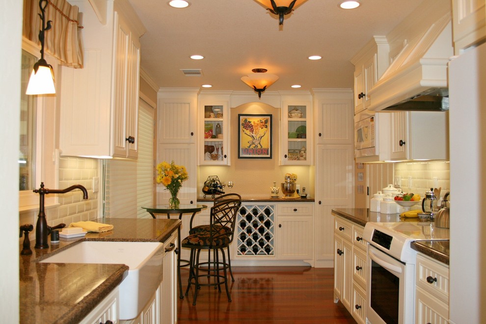 Traditional galley kitchen in San Francisco with granite benchtops and white appliances.