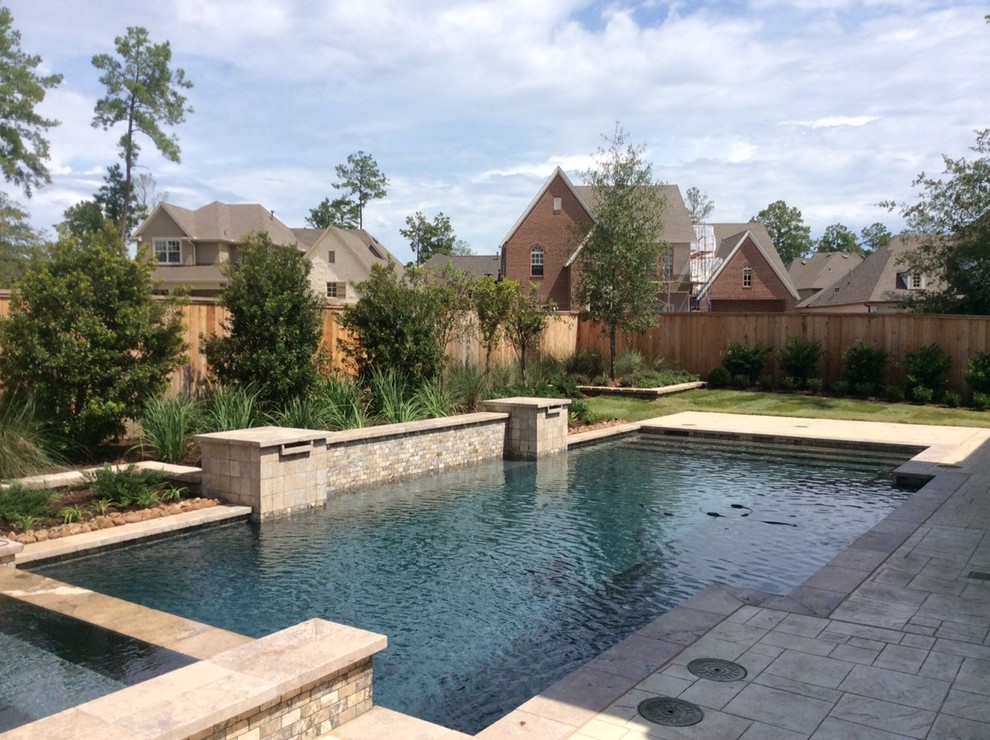 Hot tub - mid-sized transitional backyard stone and custom-shaped hot tub idea in Houston