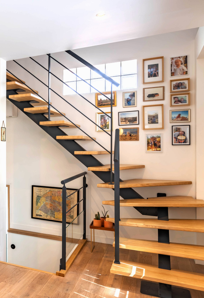 Staircase - contemporary wooden staircase idea in Paris