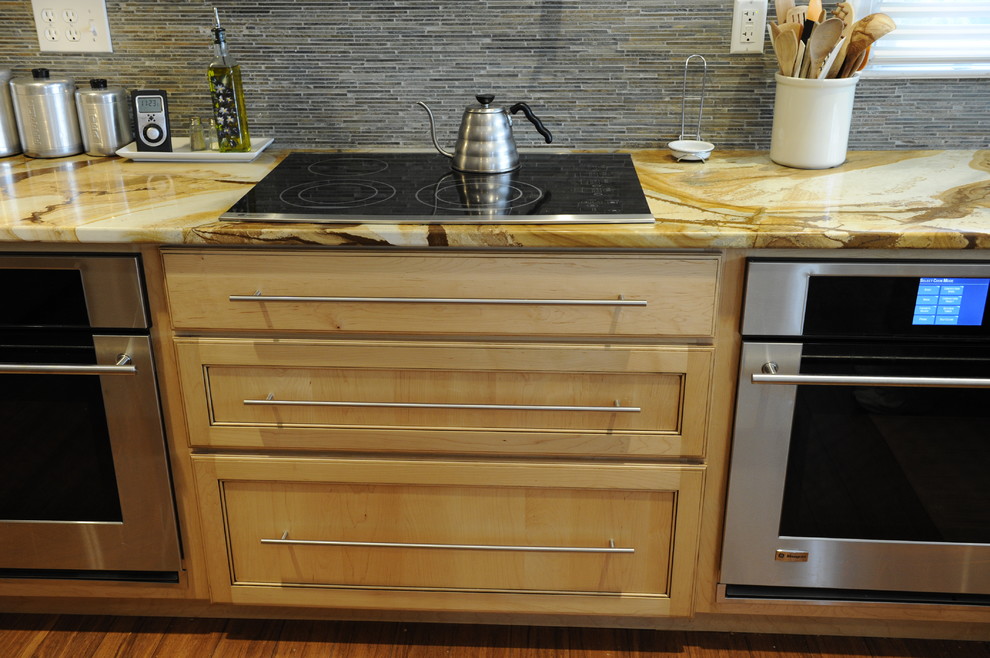 Inspiration for a mid-sized transitional u-shaped light wood floor eat-in kitchen remodel in Baltimore with a farmhouse sink, beaded inset cabinets, light wood cabinets, onyx countertops, stainless steel appliances and an island