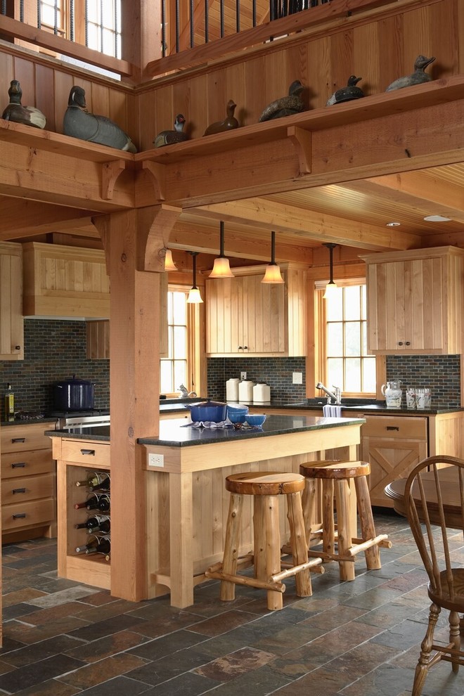 Country kitchen in Minneapolis with light wood cabinets, slate floors and slate splashback.