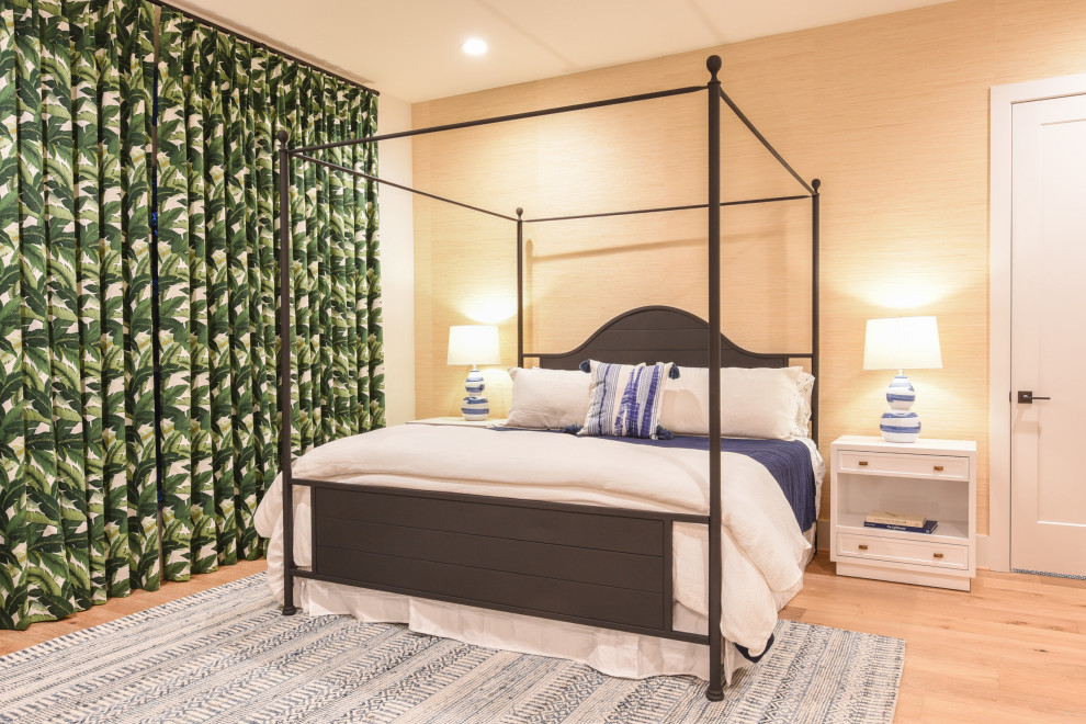 Beach style bedroom in Dallas with beige walls, light hardwood floors, beige floor and wallpaper.