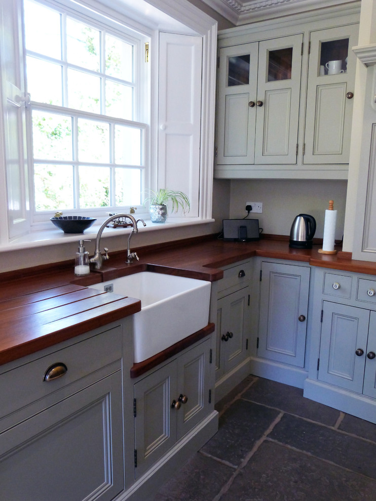 Photo of a country l-shaped open plan kitchen in Other with beaded inset cabinets and with island.
