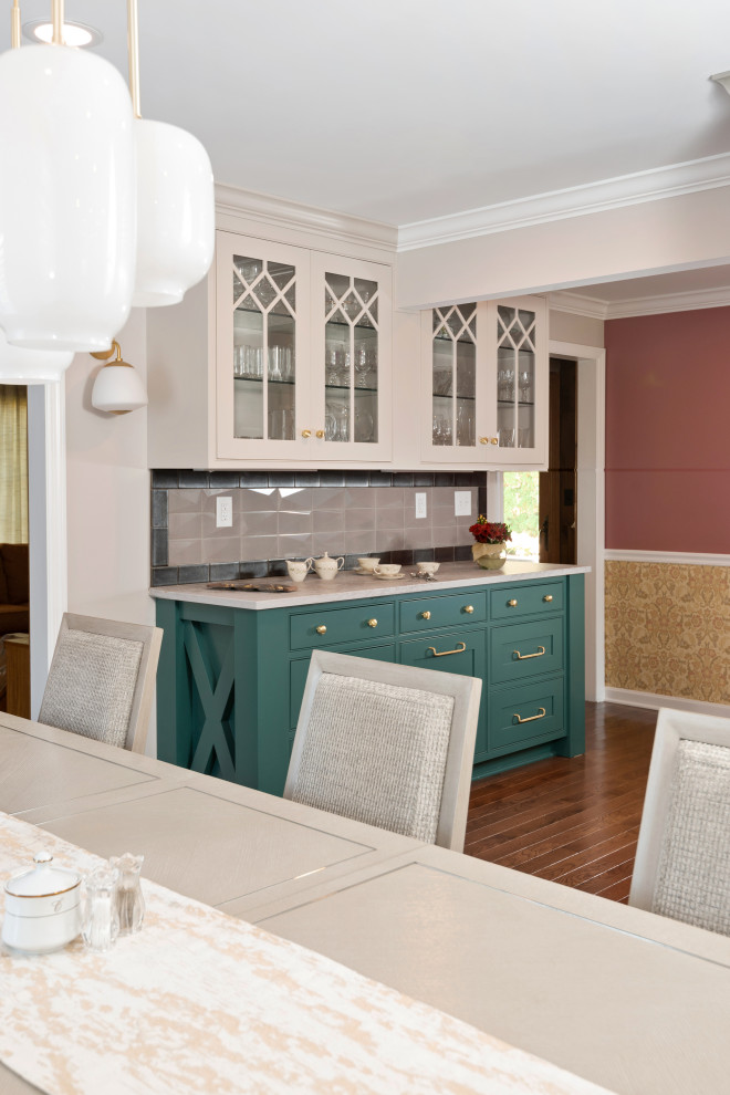 Large transitional l-shaped light wood floor and brown floor kitchen pantry photo with a farmhouse sink, beaded inset cabinets, green cabinets, quartz countertops, beige backsplash, subway tile backsplash, stainless steel appliances, an island and gray countertops