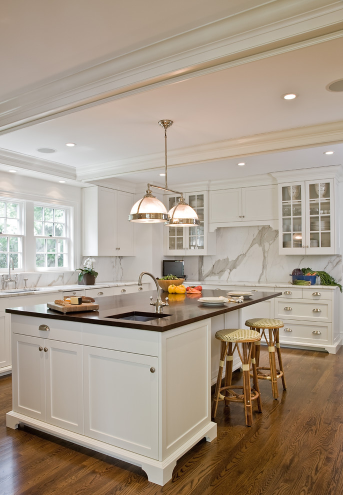 Design ideas for a traditional kitchen in Boston with glass-front cabinets.