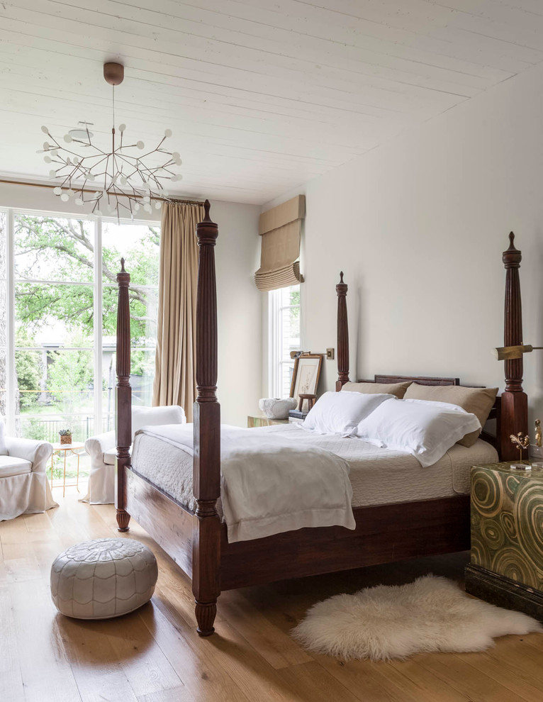 Example of a transitional master light wood floor bedroom design in Dallas with white walls